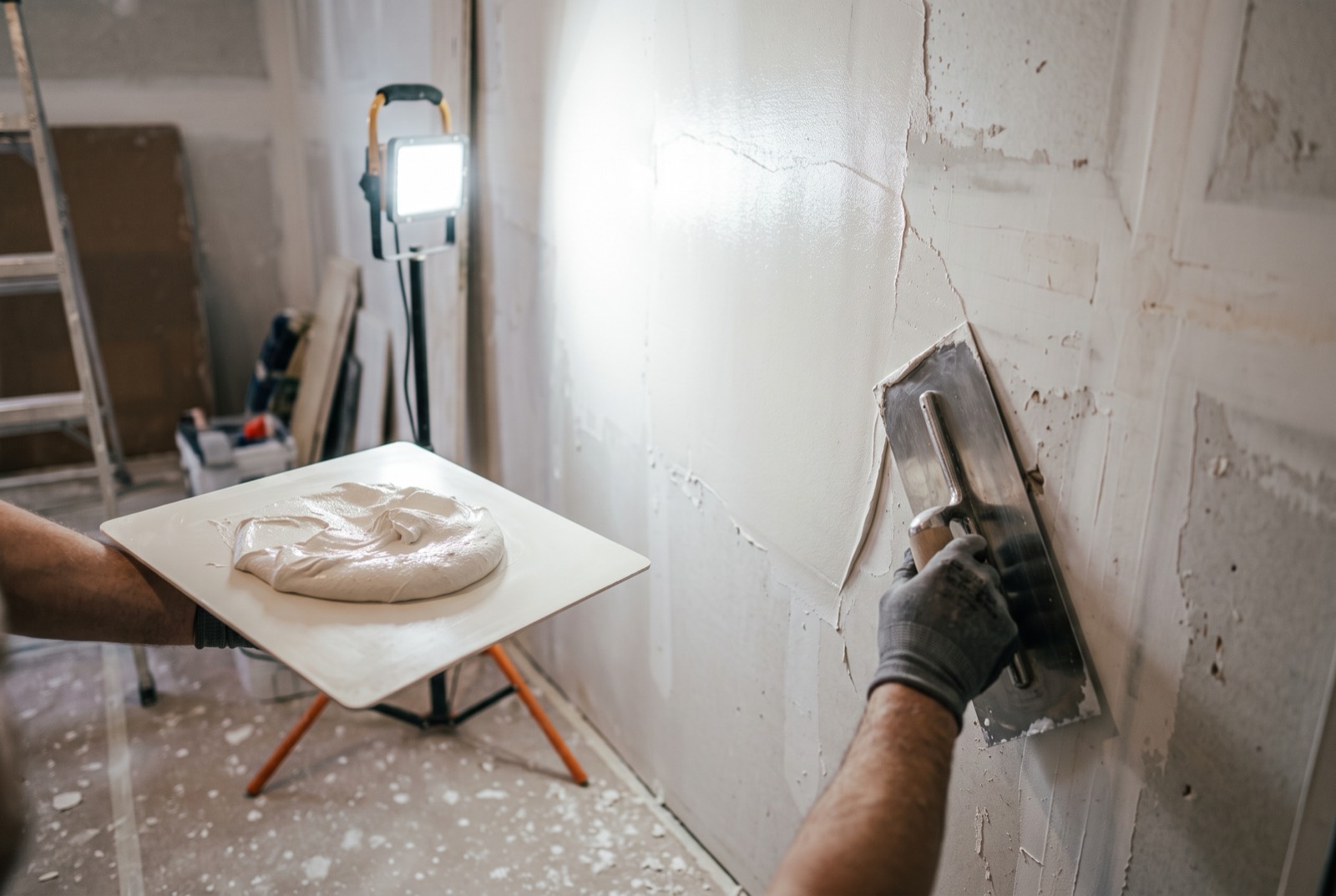 Smooth plastered wall being finished in a Singapore HDB flat before painting