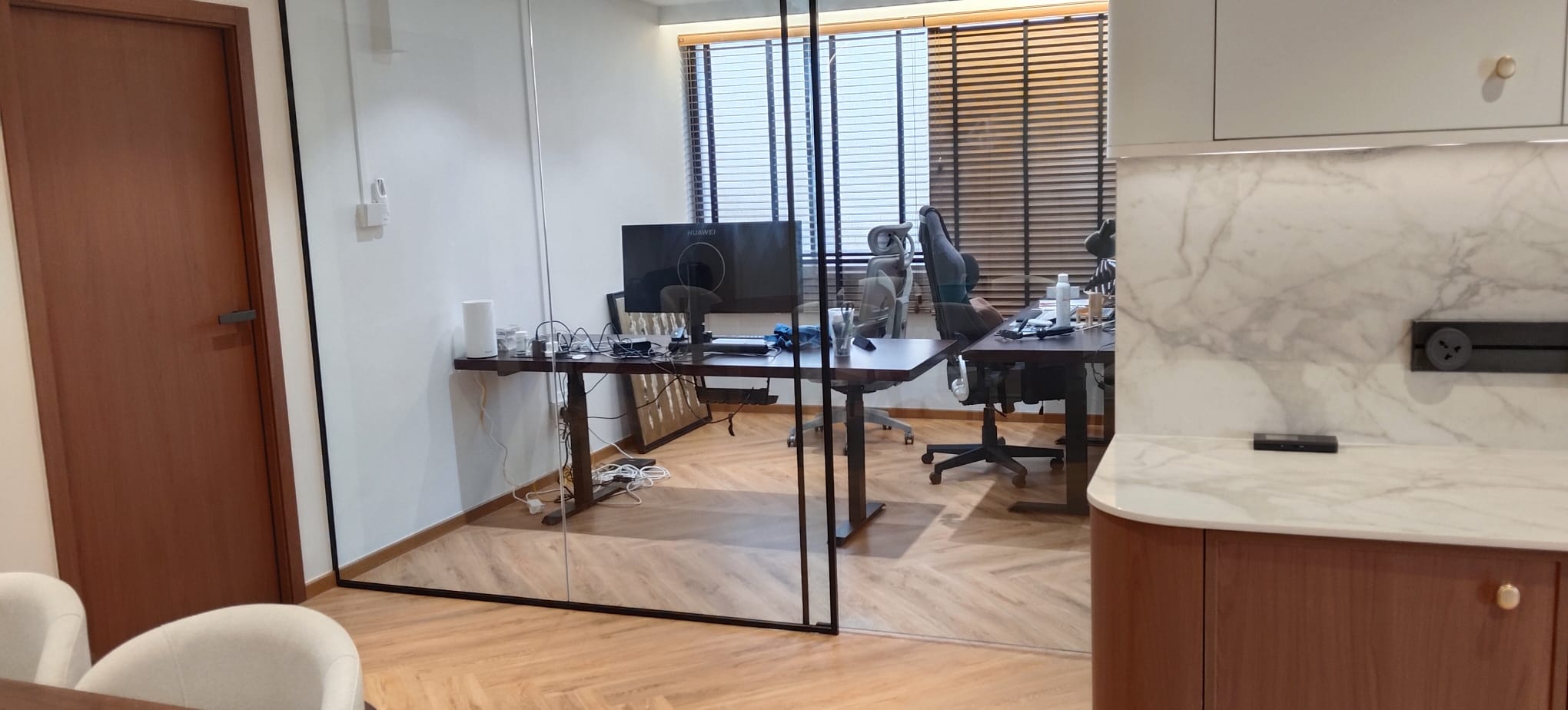 Renovated HDB home study by RK E&C with herringbone flooring, glass partition and marble counter in Bukit Panjang